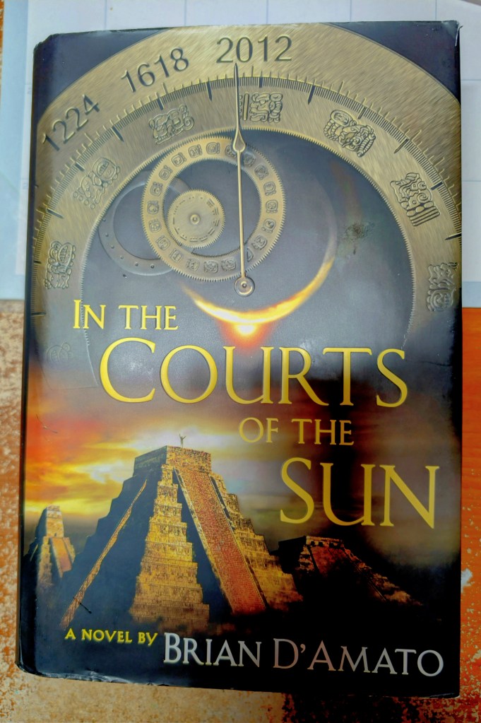 Cover of the novel 'In The Courts of The Sun' by Brian D'Amato, featuring a depiction of a Mayan pyramid and a circular calendar design.