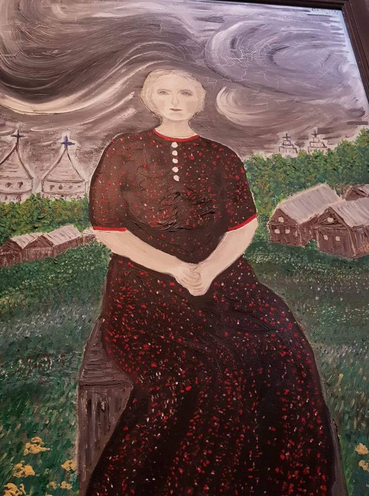 A painting of a woman in a dark dress with red accents, sitting outdoors against a backdrop of stormy skies and traditional buildings.